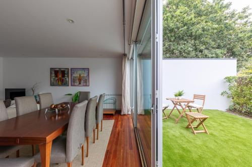 a dining room with a table and chairs at 125 House - Swimming Pool, Tennis, Golf & Nature in Esposende