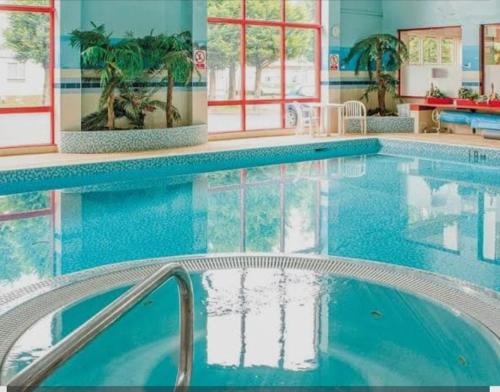 a swimming pool in a hotel room with a swimming pooliterator at Thurston Manor Caravan Park, Pony Meadow in Dunbar