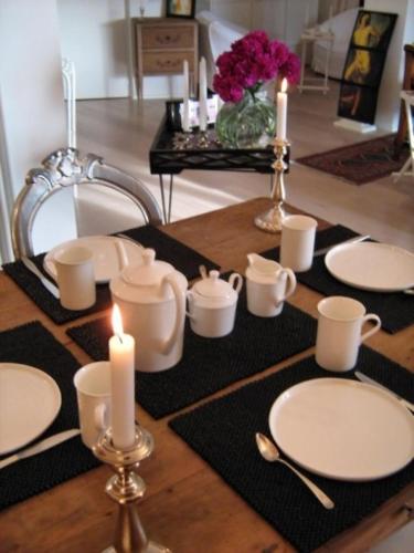 a table with white plates and candles on it at Alta Perugia B&B in Perugia