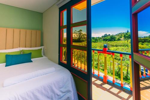 Postel nebo postele na pokoji v ubytování Hotel Bambu Guatape