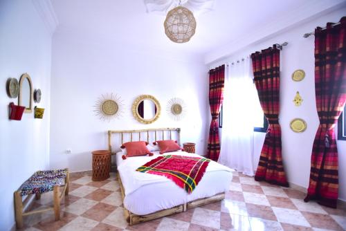 a bedroom with a bed with red pillows on it at Dar Marshan Family Luxury - Heart of Tangier in Tangier