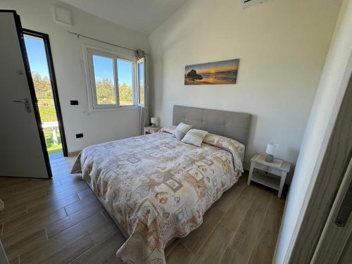 a bedroom with a bed in a room with a window at B&B Sensorial Experience in Villamassargia