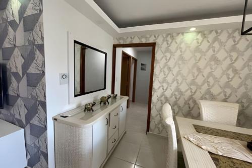 a bathroom with a sink and a mirror on a wall at Sunshine Palmares de Caleta in La Romana