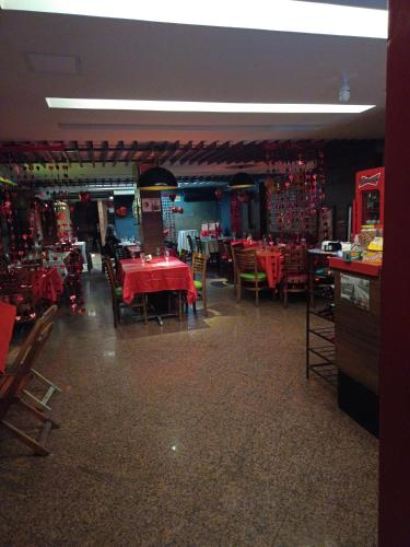 a restaurant with tables and chairs with red table cloth at PEDRA BONITA PRECIOSO HOTEL ltda in Itaboraí