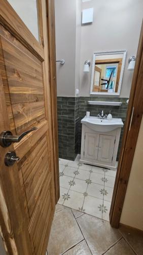 a bathroom with a sink and a mirror at Baltic Swans - Studio in Sopot