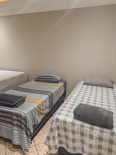 Una cama o camas en una habitación de Pousada Acessus - Familia, Amigos e Network