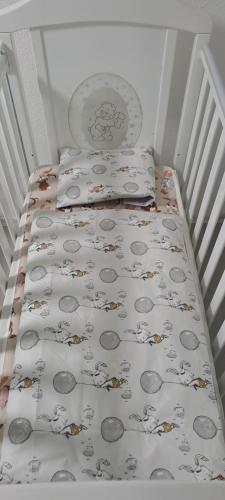 a small bed with two pillows and a blanket on it at Apartman Aydan in Jajce