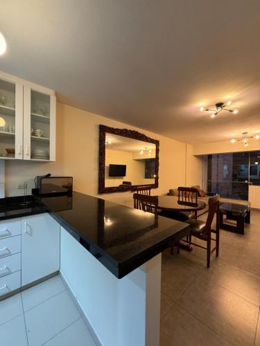 a kitchen and living room with a table and chairs at Style and location in Miraflores by AG in Lima