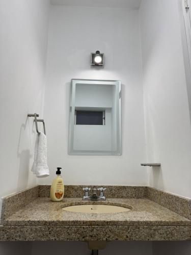 a bathroom with a sink and a mirror at Style and location in Miraflores by AG in Lima