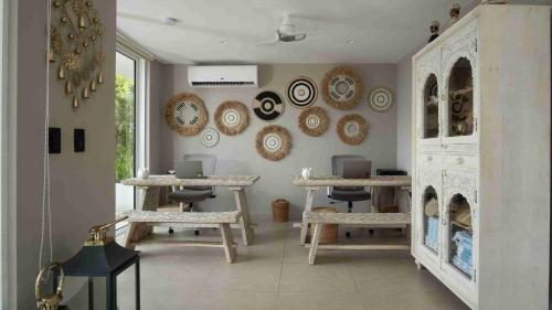 a room with two tables and plates on the wall at The Providence Hotel Boutique in San Andrés