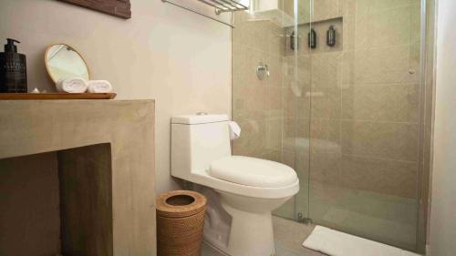 a bathroom with a toilet and a glass shower at The Providence Hotel Boutique in San Andrés