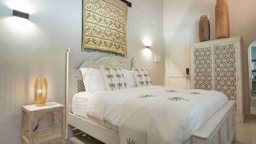 a white bedroom with a white bed with white sheets at The Providence Hotel Boutique in San Andrés