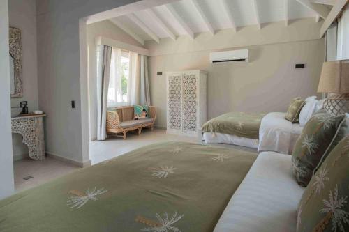 a bedroom with two beds and a living room at The Providence Hotel Boutique in San Andrés