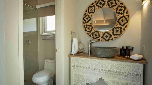 a bathroom with a sink and a mirror on a counter at The Providence Hotel Boutique in San Andrés