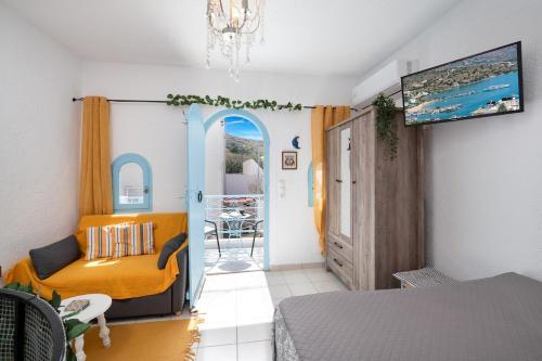a room with a bed and a couch and a table at Eloúnda blue city center WiFi traditional for two in Elounda