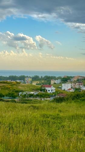 a view of a city from a field of grass at Sunset Hill Villa in Durrës