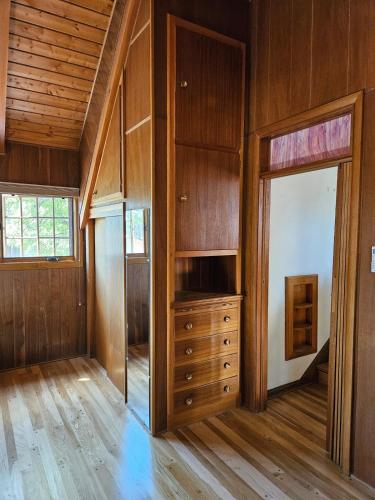 an empty room with a dresser and a window at The Hollo House in Laramie