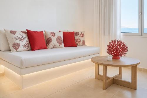 a living room with a couch and a table at Diana's Luxury Suites in Kithnos
