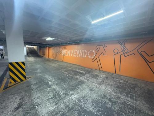 a hallway with graffiti on the wall in a parking garage at Hotel Dali Plaza Ejecutivo in Guadalajara