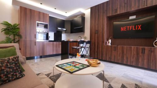 a living room with a television and a table at Escapade Chic Gare - Oasis in Casablanca