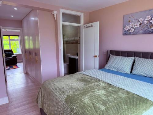 a bedroom with a bed with a blue comforter at Cherry Chirp Cottage in County Fermanagha in Garrison
