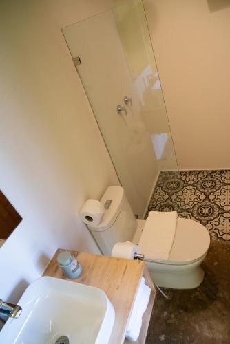 a bathroom with a toilet and a sink at Hotel con Corazon Monteverde in Monteverde Costa Rica