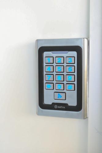 a remote control is attached to a white wall at Divos Apartments in Vlorë