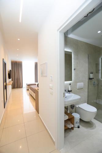a bathroom with a toilet and a sink at Divos Apartments in Vlorë
