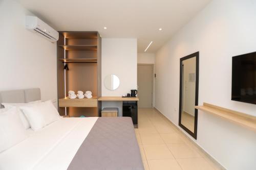 a bedroom with a large bed and a desk at Divos Apartments in Vlorë