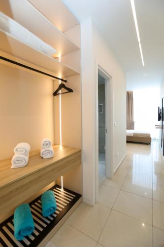 a bathroom with towels on a shelf in a room at Divos Apartments in Vlorë