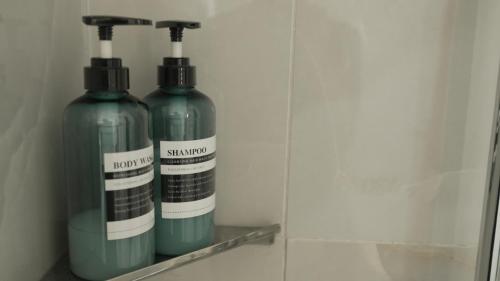 two green bottles are sitting on a shelf at Maison Jacob - Hyper centre - Maison historique - Air conditioning - Wifi in Avignon