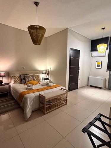 a large bedroom with a large bed and a table at Mytilene Luxury Villa Panoramic in Mytilini