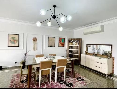 a dining room with a table and some chairs at Family apartment at The Nile maadi in Cairo