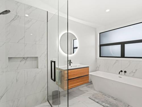 a bathroom with a shower and a tub and a sink at Entire Hawea Holiday Home near Wanaka 2-10 guests in Lake Hawea