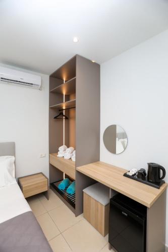 a bedroom with a bed and a desk in a room at Divos Apartments in Vlorë
