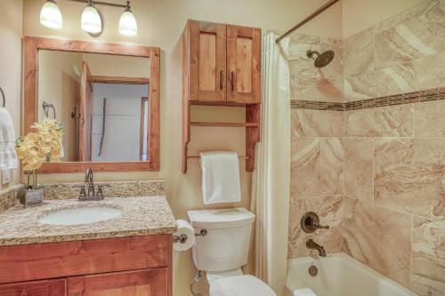 a bathroom with a toilet and a sink and a shower at 10 Cobblestone Ln in Pagosa Springs