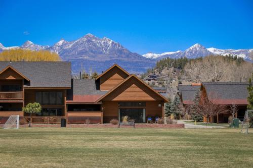 a log home with mountains in the background at 10 Cobblestone Ln in Pagosa Springs