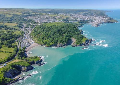 an aerial view of the shoreline of a island in the ocean at Beach Cove Coastal Retreat in Ilfracombe