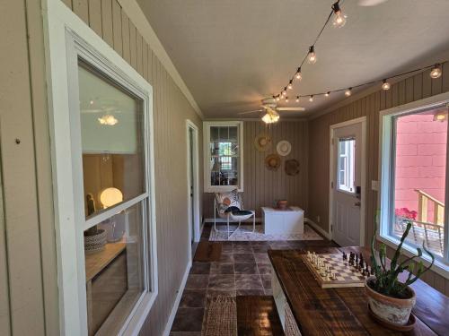a room with a table and a chessboard on the floor at Old School Charm | Sleeps 6 in Buchanan