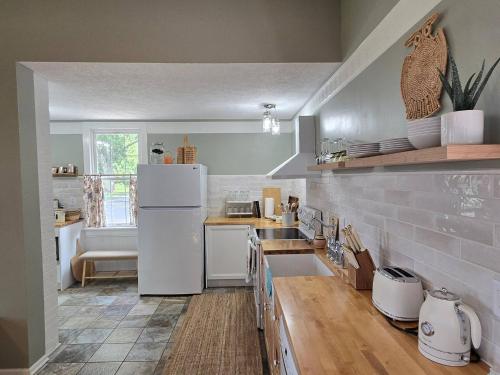 a kitchen with a white refrigerator and a sink at Old School Charm | Sleeps 6 in Buchanan