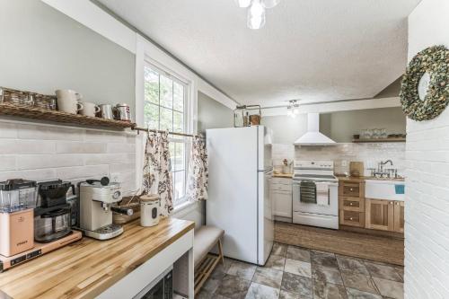 a kitchen with white appliances and a white refrigerator at Old School Charm | Sleeps 6 in Buchanan
