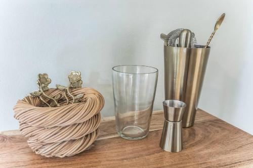 a wooden table with two vases and a glass at Old School Charm | Sleeps 6 in Buchanan