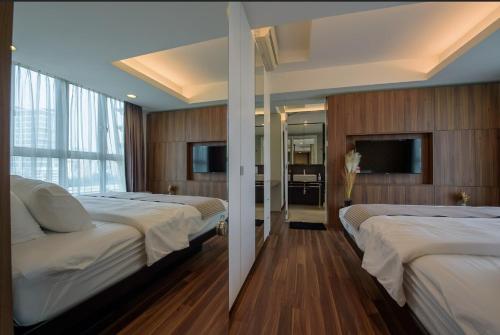 a hotel room with two beds and a television at Luxury 22 Home 6Pax Old Klang Road Mid Valley KL Centre in Kuala Lumpur