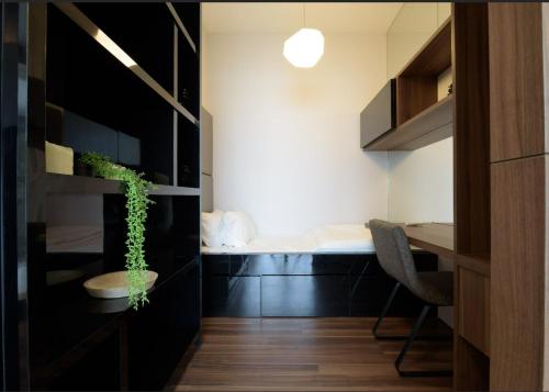 a room with a bed and a desk with a plant at Luxury 22 Home 6Pax Old Klang Road Mid Valley KL Centre in Kuala Lumpur