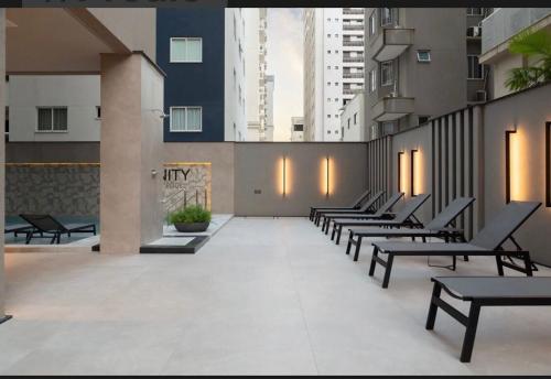 a row of benches in a building with buildings at Para pessoas exigentes Para pessoas exigentes in Itapema