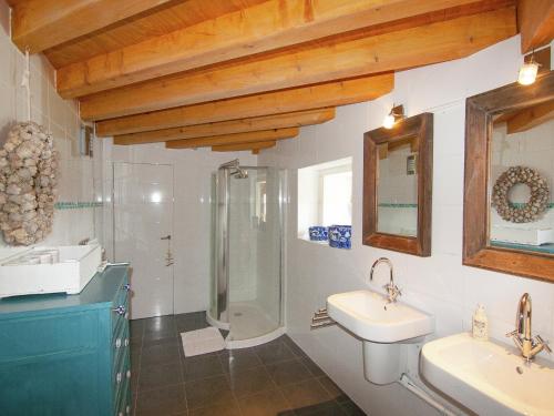 a bathroom with a shower and two sinks and a shower at Very nice cottage with studio on a domain with heated pool in Roussines