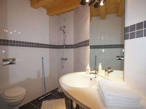 a bathroom with a sink and a toilet at Very nice cottage with studio on a domain with heated pool in Roussines
