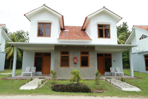 a house with chairs in front of it at Sanghyang Indah Spa Resort in Anyer
