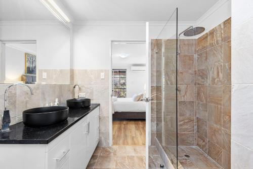 a bathroom with two sinks and a shower at The Bishops Escape A Sepal Stay in Perth