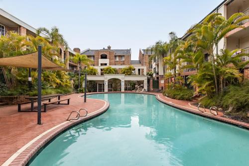 a swimming pool in a courtyard with a building at The Bishops Escape A Sepal Stay in Perth
